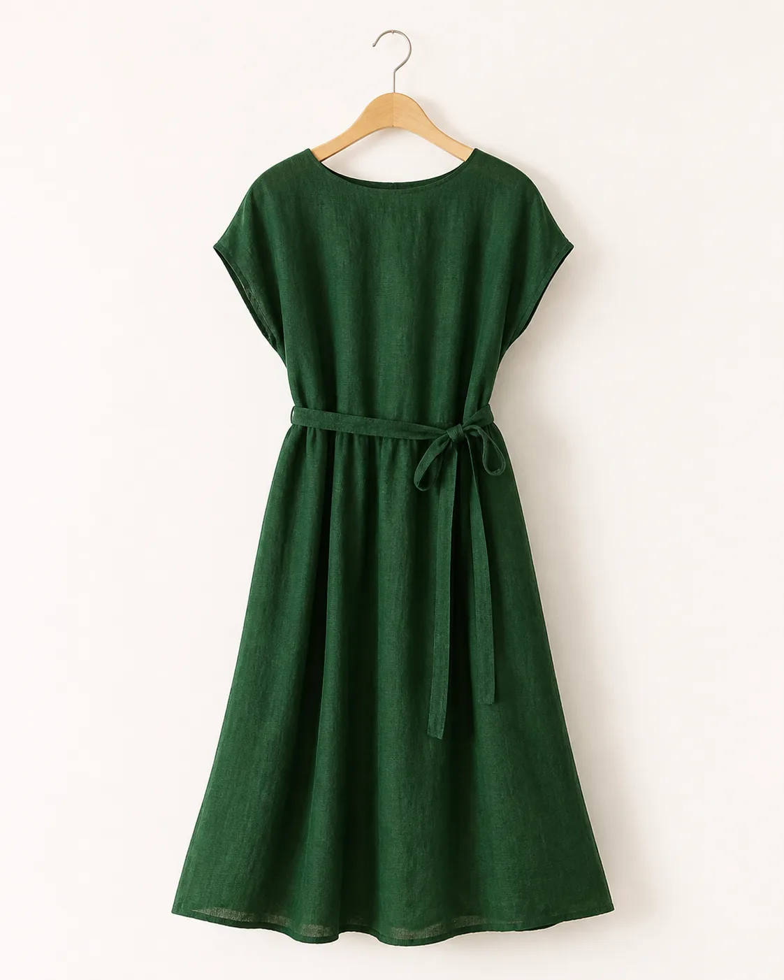 Forest green linen midi dress on a wooden hanger